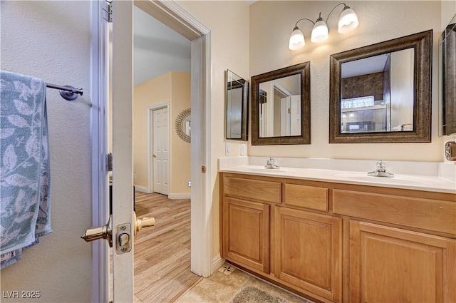 9370 Corkfish St, Las Vegas, NV 89178 - full bathroom featuring double vanity, wood finished floors, and baseboards