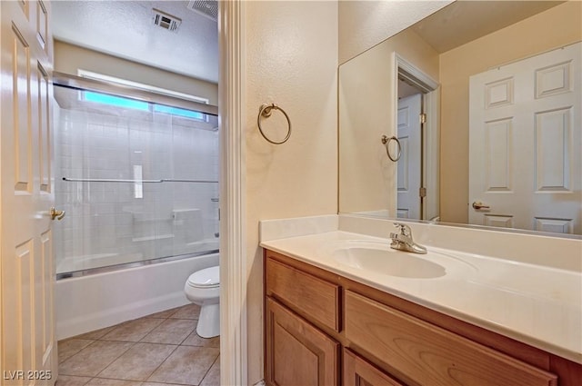 9370 Corkfish St, Las Vegas, NV 89178 - full bathroom featuring toilet, tile patterned floors, vanity, and combined bath / shower with glass door