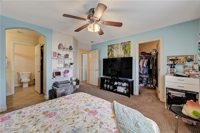 9370 Corkfish St, Las Vegas, NV 89178 - bedroom featuring arched walkways, a walk in closet, a closet, ceiling fan, and ensuite bath