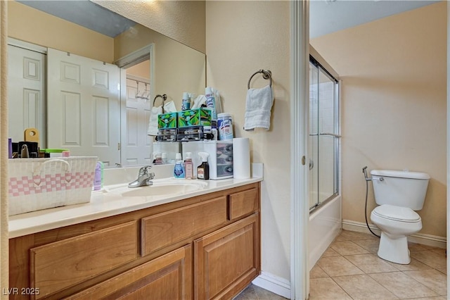 9370 Corkfish St, Las Vegas, NV 89178 - full bathroom featuring toilet, vanity, tile patterned flooring, bath / shower combo with glass door, and baseboards