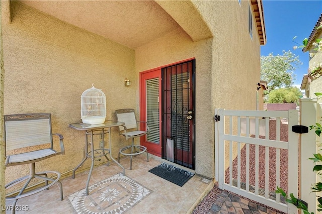9370 Corkfish St, Las Vegas, NV 89178 - doorway to property with stucco siding, a gate, and a patio