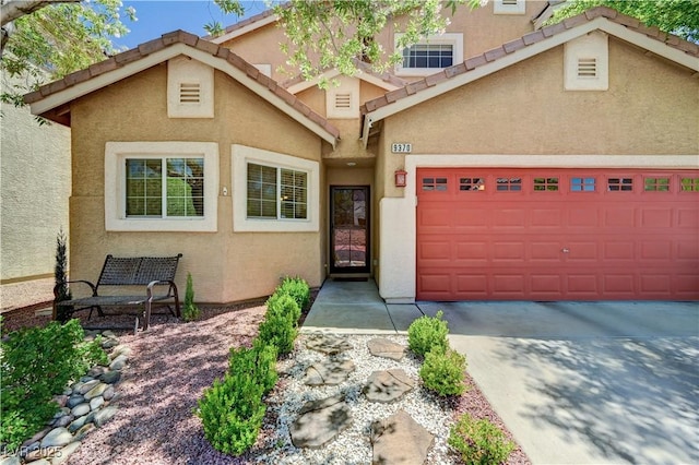 9370 Corkfish St, Las Vegas, NV 89178 - view of front of property with stucco siding, an attached garage, and concrete driveway