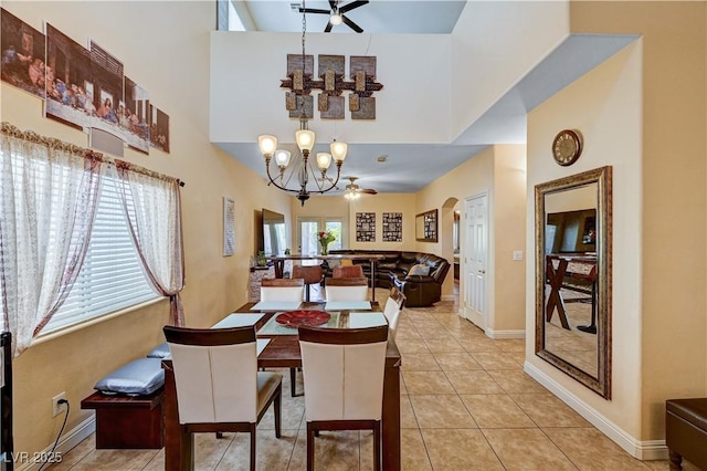 9370 Corkfish St, Las Vegas, NV 89178 - dining area featuring ceiling fan, a high ceiling, a chandelier, light tile patterned floors, and arched walkways