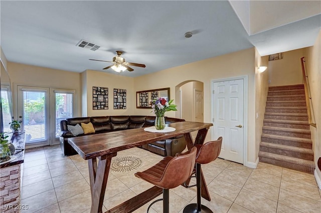 9370 Corkfish St, Las Vegas, NV 89178 - dining room featuring stairs, ceiling fan, arched walkways, light tile patterned floors, and baseboards