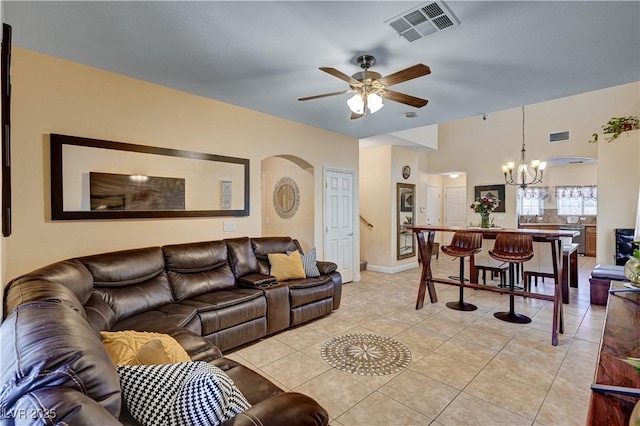 9370 Corkfish St, Las Vegas, NV 89178 - living area featuring arched walkways, a chandelier, ceiling fan, light tile patterned floors, and baseboards