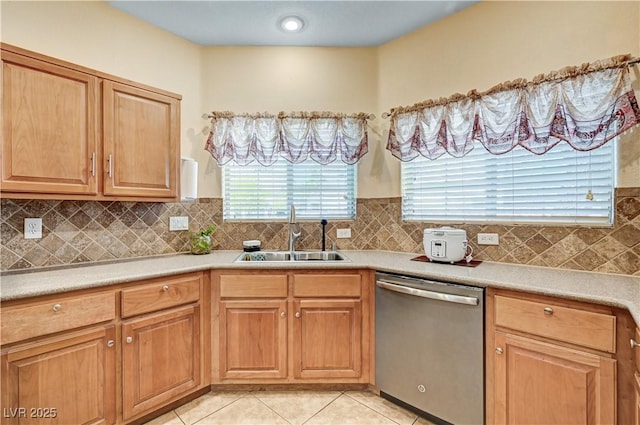 9370 Corkfish St, Las Vegas, NV 89178 - kitchen featuring stainless steel dishwasher, a sink, light tile patterned floors, light countertops, and backsplash