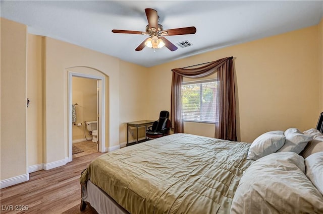 9370 Corkfish St, Las Vegas, NV 89178 - bedroom with wood finished floors, baseboards, a ceiling fan, and connected bathroom