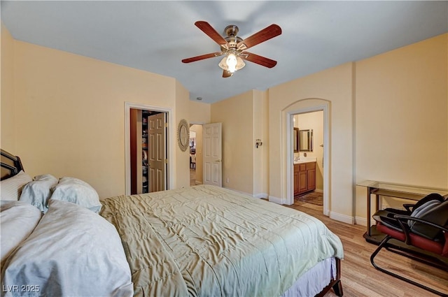 9370 Corkfish St, Las Vegas, NV 89178 - bedroom with light wood-type flooring, baseboards, a ceiling fan, and ensuite bathroom