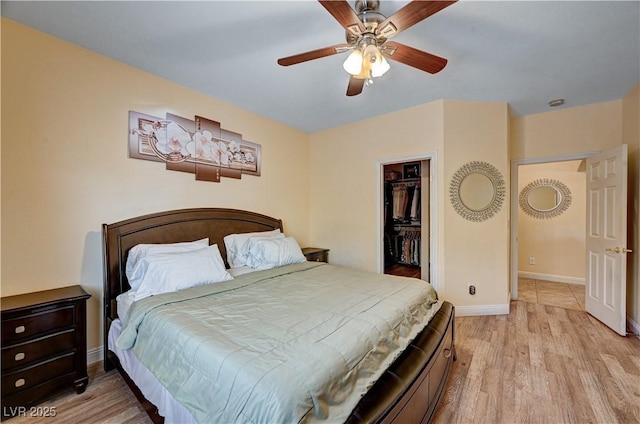 9370 Corkfish St, Las Vegas, NV 89178 - bedroom with light wood finished floors, baseboards, a closet, a walk in closet, and ceiling fan