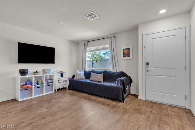 2598 Polar White Ave, North Las Vegas, NV 89086 - living room featuring light wood-style flooring, baseboards, and recessed lighting