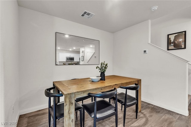 2598 Polar White Ave, North Las Vegas, NV 89086 - dining room featuring wood finished floors, baseboards, and stairway