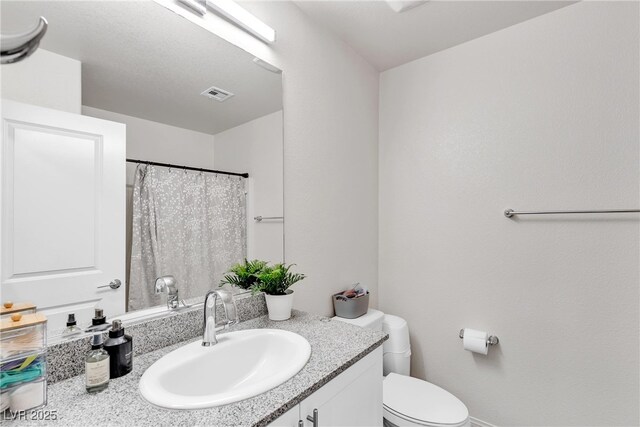 2598 Polar White Ave, North Las Vegas, NV 89086 - full bathroom with vanity, toilet, and a shower with shower curtain