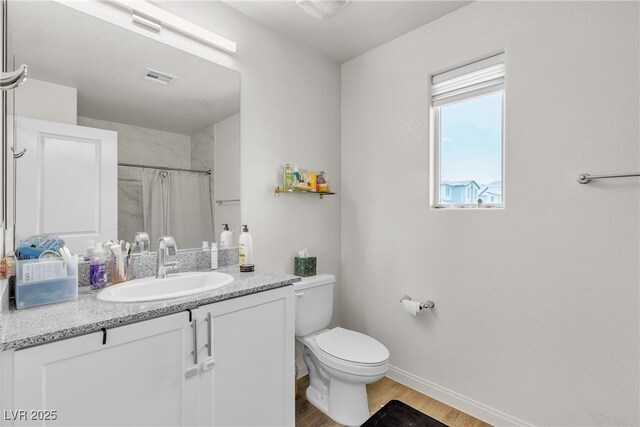 2598 Polar White Ave, North Las Vegas, NV 89086 - bathroom with wood finished floors, toilet, baseboards, vanity, and a shower with shower curtain