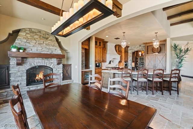 20 Via Paradiso St, Henderson, NV 89011 - dining area with beamed ceiling, a fireplace, light stone finish floors, arched walkways, and recessed lighting