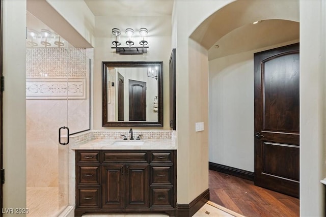 20 Via Paradiso St, Henderson, NV 89011 - bathroom featuring wood finished floors, a stall shower, vanity, and backsplash