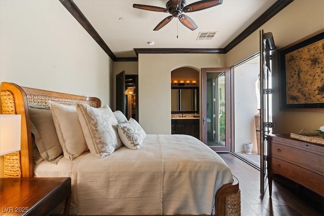 20 Via Paradiso St, Henderson, NV 89011 - bedroom with arched walkways, crown molding, hardwood / wood-style flooring, a sink, and ensuite bath
