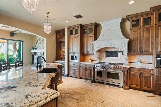20 Via Paradiso St, Henderson, NV 89011 - kitchen with range with two ovens, a fireplace, premium range hood, recessed lighting, and decorative backsplash