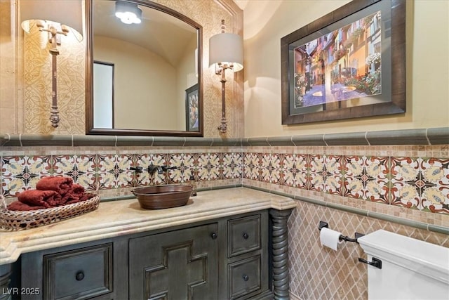20 Via Paradiso St, Henderson, NV 89011 - half bathroom featuring vanity, toilet, tile walls, and wainscoting
