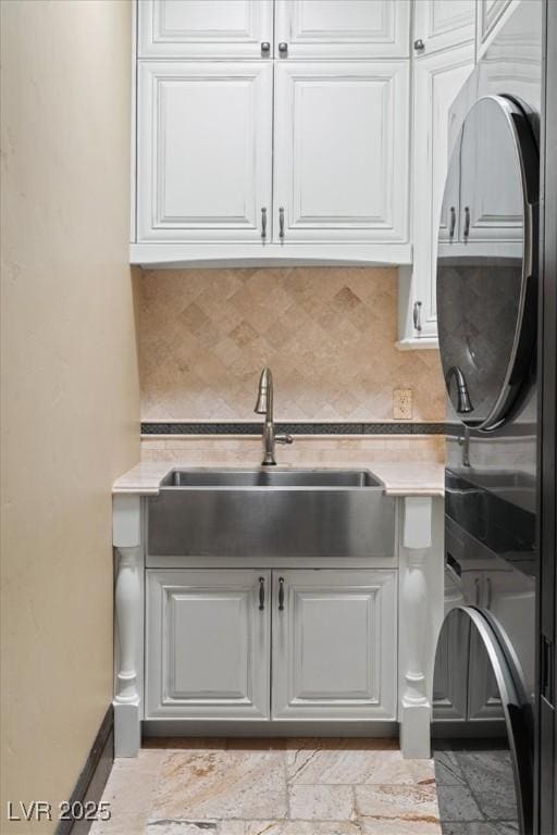 20 Via Paradiso St, Henderson, NV 89011 - kitchen featuring stacked washer / drying machine, a sink, light countertops, and backsplash