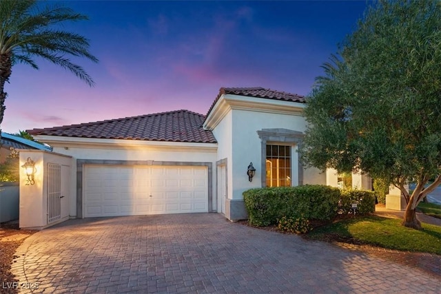 20 Via Paradiso St, Henderson, NV 89011 - mediterranean / spanish-style house with a tiled roof, a garage, stucco siding, and decorative driveway