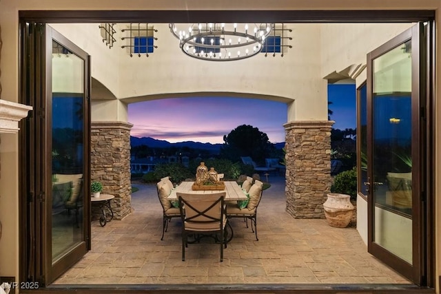 20 Via Paradiso St, Henderson, NV 89011 - patio terrace at dusk with outdoor dining area, a patio, and a mountain view