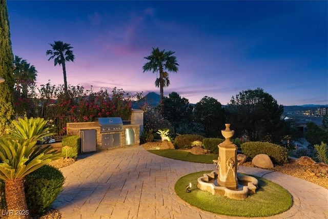 20 Via Paradiso St, Henderson, NV 89011 - view of front of home featuring area for grilling, curved driveway, and a patio area