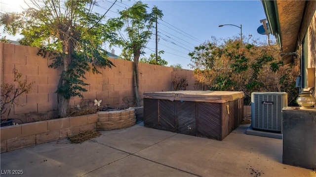 305 Crosswind Way, Las Vegas, NV 89145 - fenced backyard featuring a hot tub, a patio area, and central AC unit