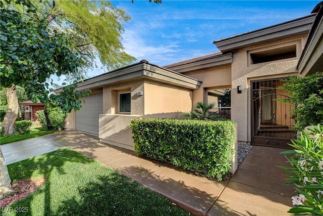 9921 Mirada Dr, Las Vegas, NV 89144 - view of side of home with stucco siding, concrete driveway, and a garage