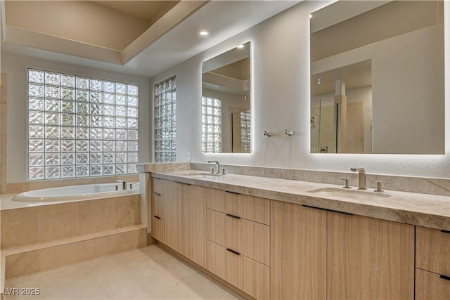 9921 Mirada Dr, Las Vegas, NV 89144 - bathroom with double vanity, a bath, a shower with shower door, and tile patterned flooring
