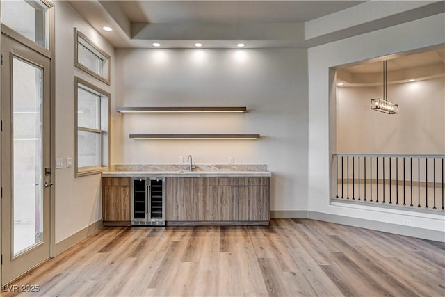 9921 Mirada Dr, Las Vegas, NV 89144 - indoor wet bar featuring wine cooler, light wood-style floors, baseboards, healthy amount of natural light, and recessed lighting