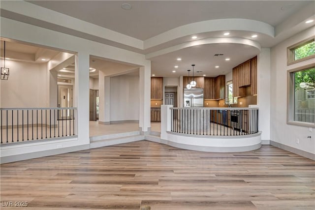 9921 Mirada Dr, Las Vegas, NV 89144 - kitchen with stainless steel built in refrigerator, light wood-style floors, brown cabinetry, open floor plan, and recessed lighting