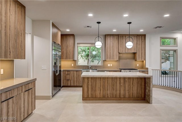 9921 Mirada Dr, Las Vegas, NV 89144 - kitchen with stainless steel built in refrigerator, modern cabinets, a sink, a kitchen island, and light countertops