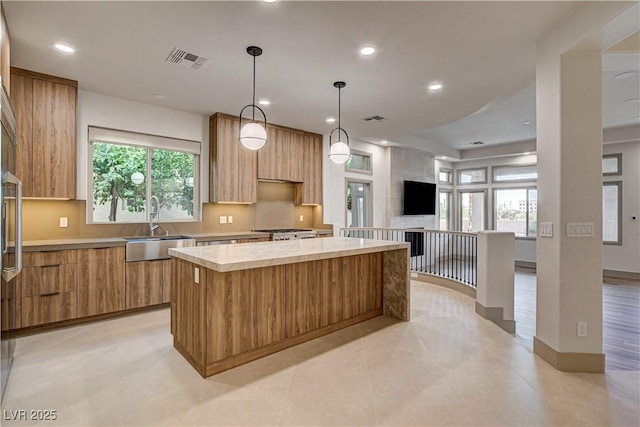 9921 Mirada Dr, Las Vegas, NV 89144 - kitchen featuring a sink, modern cabinets, light countertops, a center island, and recessed lighting