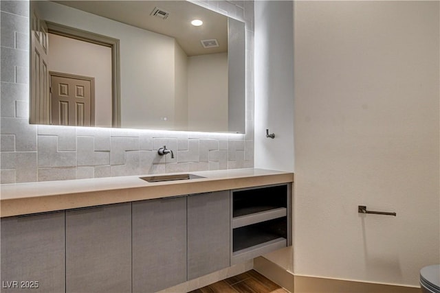 9921 Mirada Dr, Las Vegas, NV 89144 - bathroom with vanity, decorative backsplash, and wood finished floors