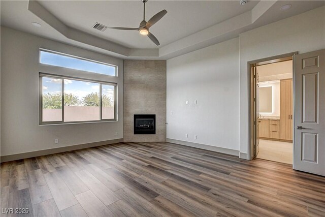 9921 Mirada Dr, Las Vegas, NV 89144 - unfurnished living room with a ceiling fan, a tray ceiling, and wood finished floors