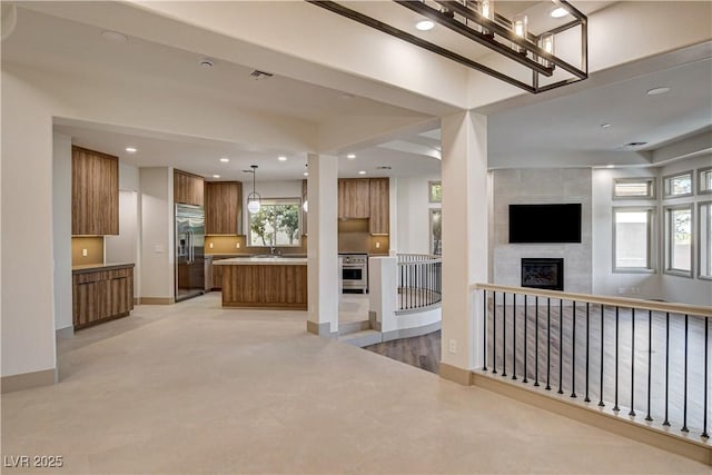 9921 Mirada Dr, Las Vegas, NV 89144 - unfurnished living room featuring a tiled fireplace, recessed lighting, and baseboards