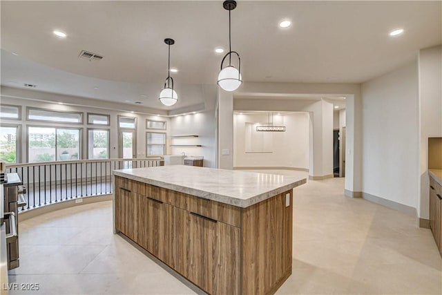 9921 Mirada Dr, Las Vegas, NV 89144 - kitchen featuring modern cabinets, a kitchen island, light countertops, brown cabinets, and recessed lighting