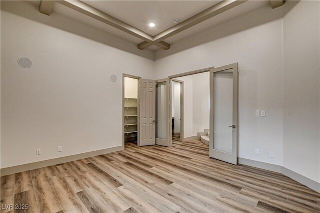 9921 Mirada Dr, Las Vegas, NV 89144 - unfurnished bedroom with light wood-style floors, a walk in closet, beam ceiling, recessed lighting, and a closet
