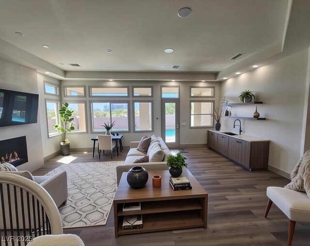 9921 Mirada Dr, Las Vegas, NV 89144 - living area with a fireplace, dark wood-style floors, and recessed lighting