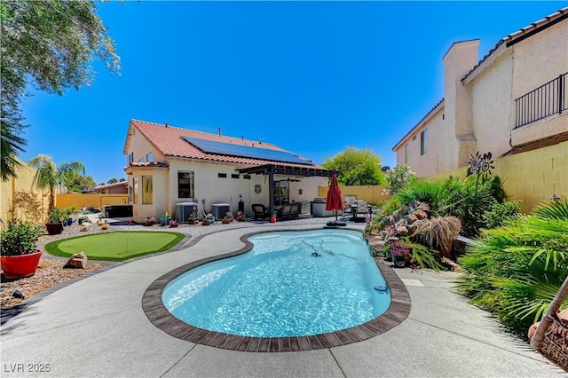 1028 Dodger Blue Ave, Las Vegas, NV 89123 - view of pool featuring a putting green, a patio, central AC, and a fenced backyard