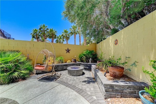 1028 Dodger Blue Ave, Las Vegas, NV 89123 - fenced backyard with an outdoor fire pit and a patio area