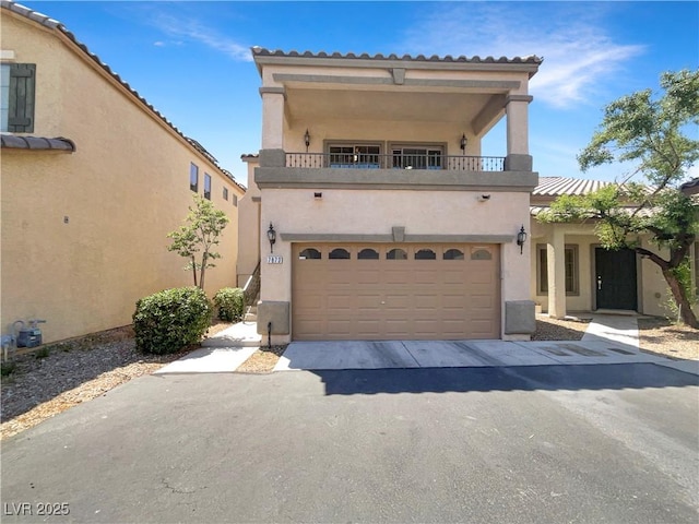7873 Running Doe Ct, Las Vegas, NV 89149 - mediterranean / spanish house with a balcony, stucco siding, driveway, and a garage