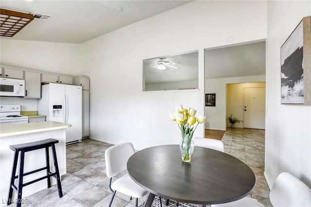 1012 Winwood St, Las Vegas, NV 89108 - dining room with ceiling fan, light tile patterned flooring, and vaulted ceiling