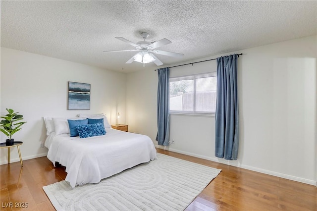 1012 Winwood St, Las Vegas, NV 89108 - bedroom featuring wood finished floors, a textured ceiling, baseboards, and ceiling fan
