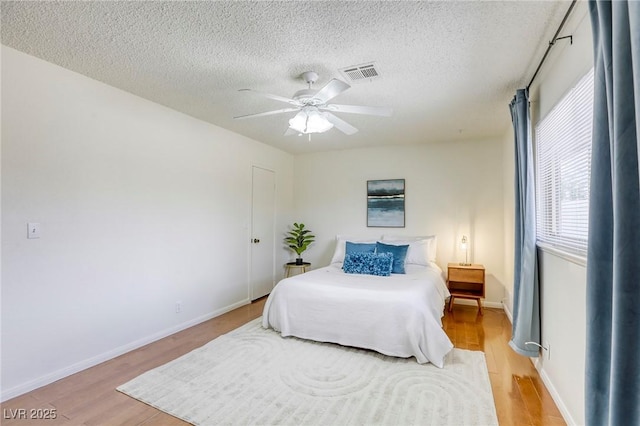 1012 Winwood St, Las Vegas, NV 89108 - bedroom with light wood finished floors, a textured ceiling, ceiling fan, and baseboards