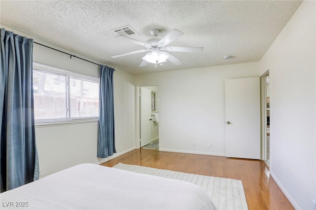 1012 Winwood St, Las Vegas, NV 89108 - bedroom featuring wood finished floors, a textured ceiling, ceiling fan, and baseboards