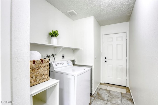 1012 Winwood St, Las Vegas, NV 89108 - washroom with washer / dryer, a textured ceiling, baseboards, and light tile patterned floors