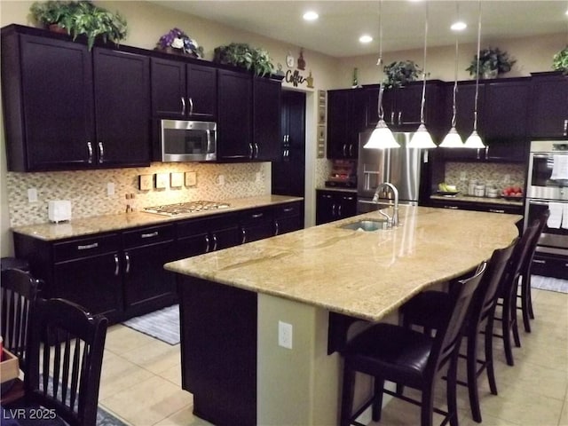 4242 Helena Hideaway Ct, Las Vegas, NV 89129 - kitchen with stainless steel appliances, a sink, light tile patterned floors, light stone countertops, and tasteful backsplash