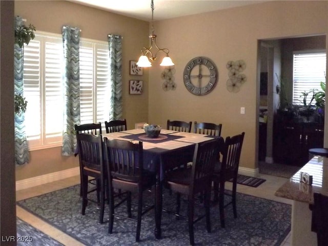 4242 Helena Hideaway Ct, Las Vegas, NV 89129 - dining room featuring baseboards, a chandelier, and tile patterned floors