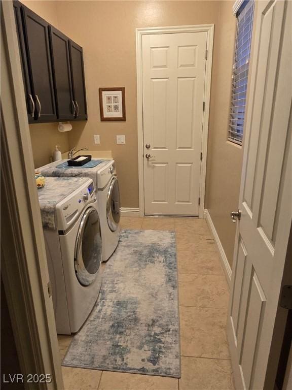 4242 Helena Hideaway Ct, Las Vegas, NV 89129 - laundry area with independent washer and dryer, cabinet space, light tile patterned floors, and baseboards